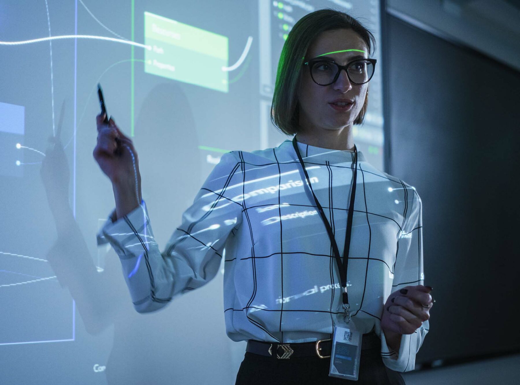 A woman points at a projected screen