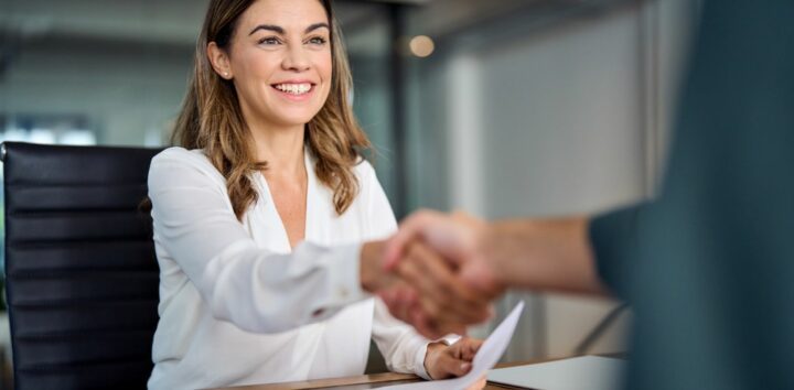 A lady shaking hands in an office