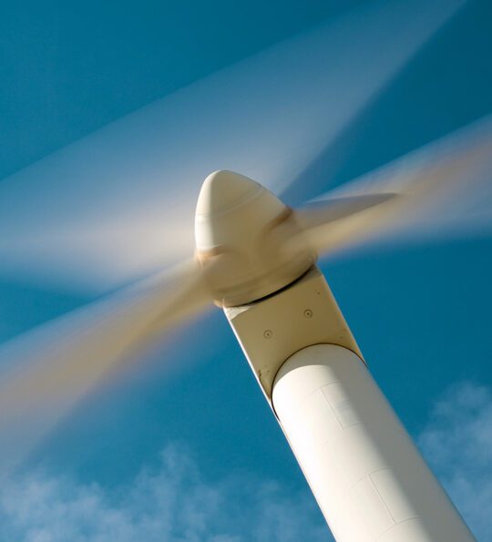 A wind turbine, viewed from below