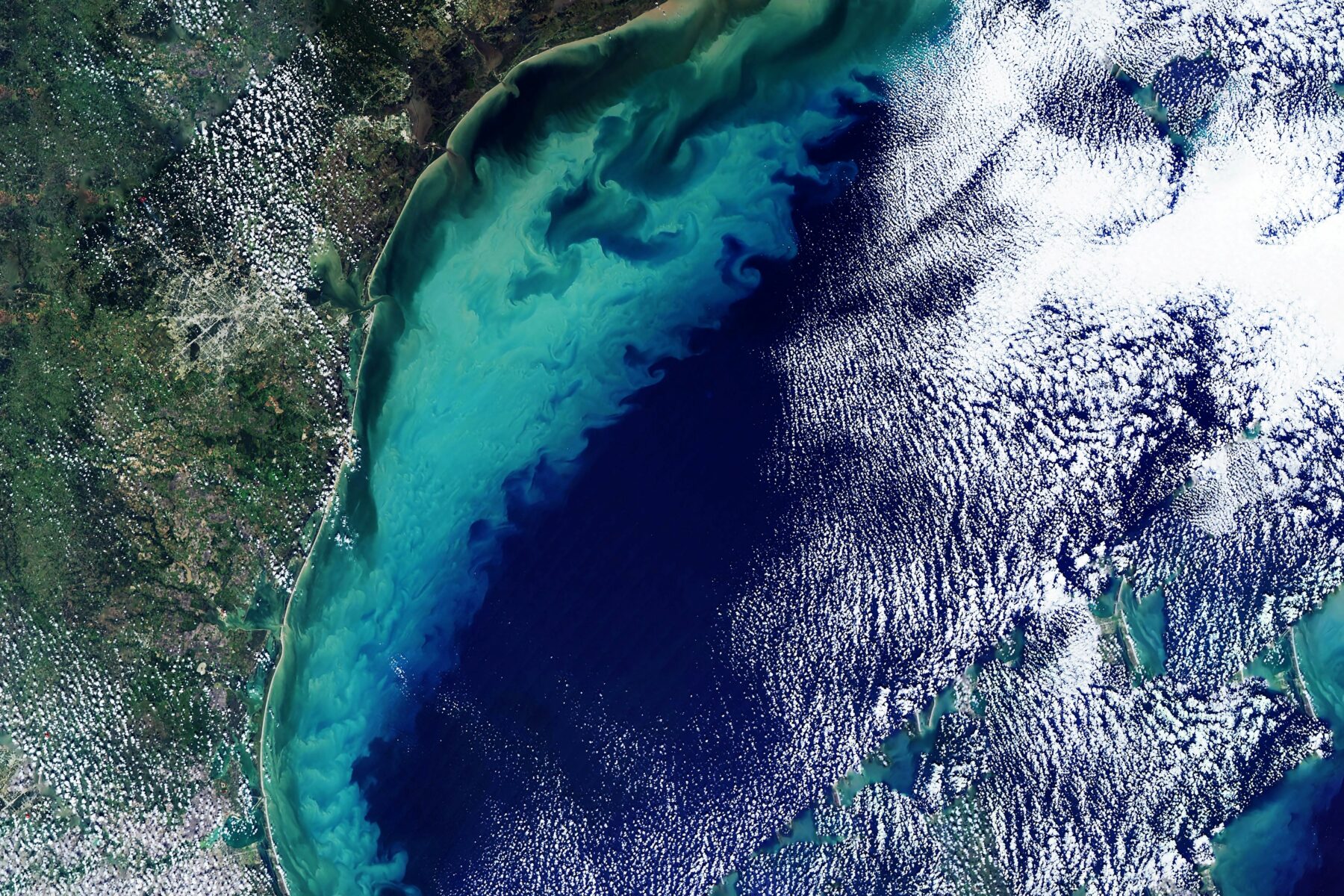 Satellite image of a coast line with cloud