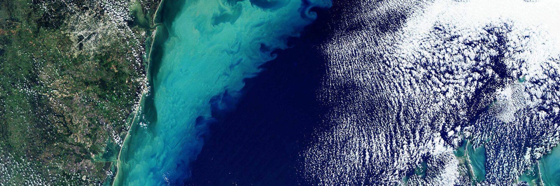 Satellite image of a coast line with cloud